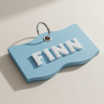 Close-up of raised lettering and metal ring on a wavy pet ID tag