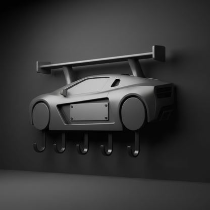 Generic sports-car-inspired wall key rack with a blank name plate in a dark studio setting