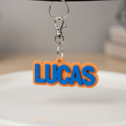 Close-up of a personalized 3D-printed name keychain and metal hardware