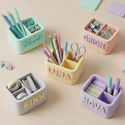 Several colorful personalized 3D-printed desk organizers arranged together