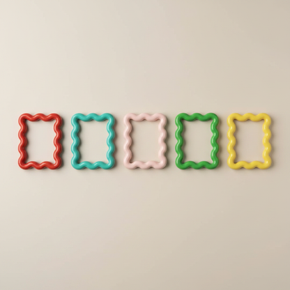 Five bold wavy magnetic picture frames in red, turquoise, pink, green, and yellow